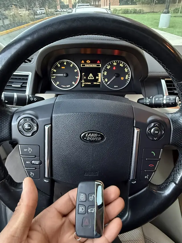 Range Rover smart key held in front of the steering wheel