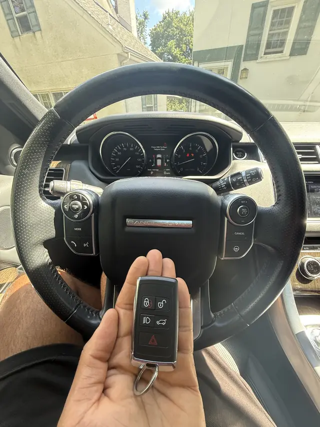 Range Rover Sport smart key held in front of the steering wheel