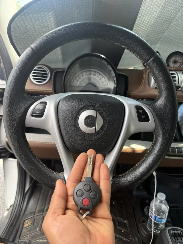 Smart fortwo key held in front of the steering wheel